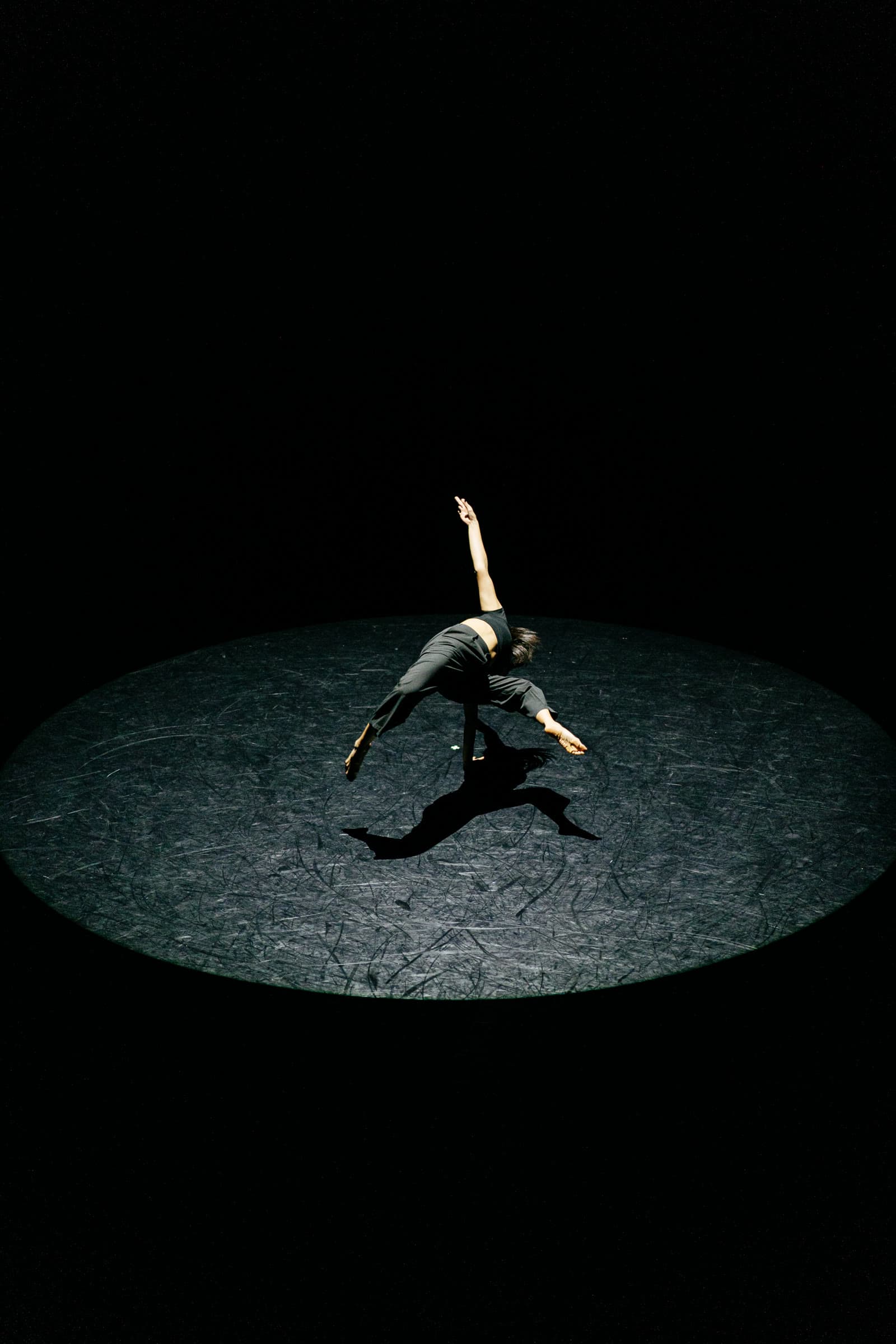 Amberly dancing in spotlight from above